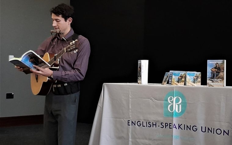David Fisher performing with his guitar