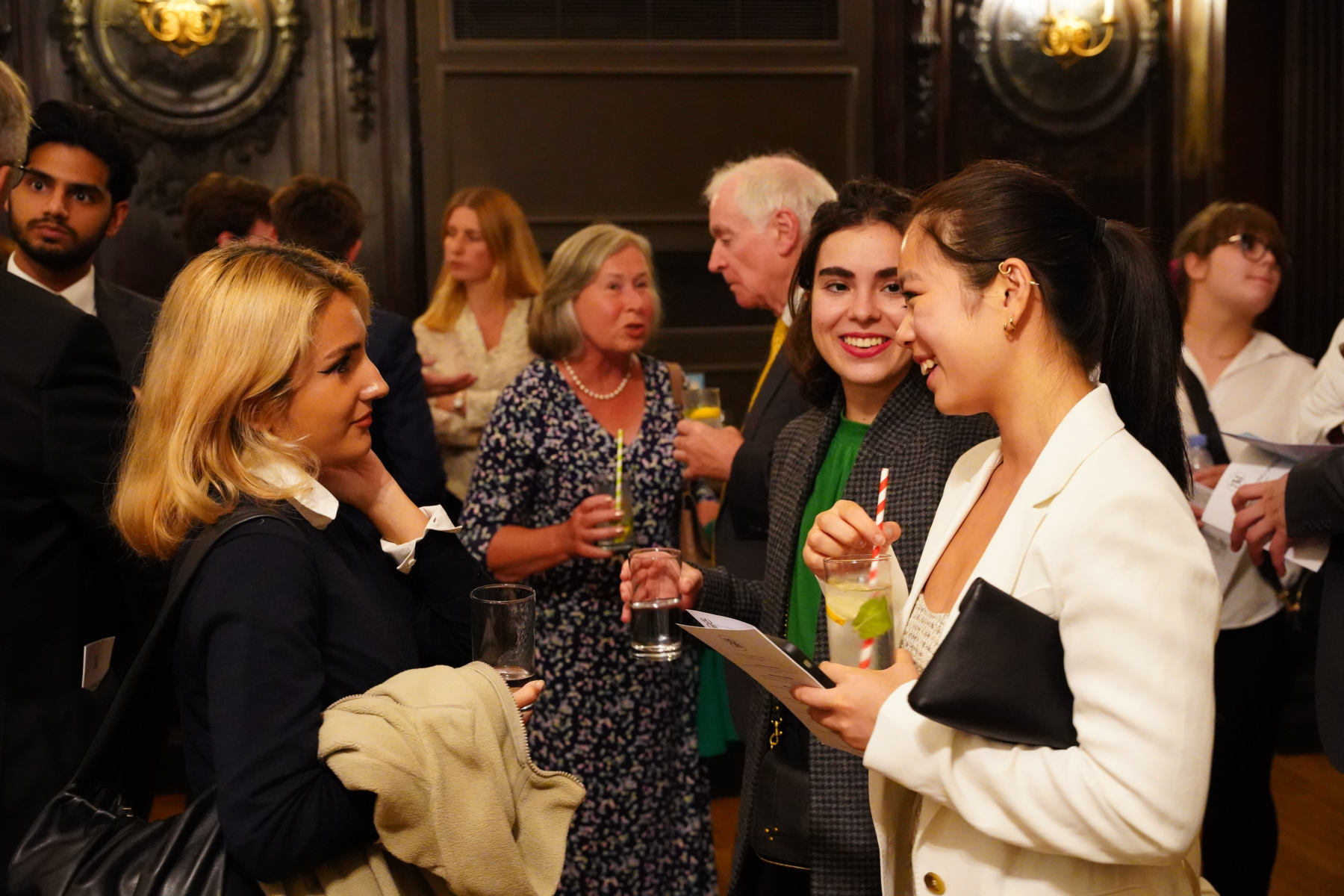 Young scholars talking at drinks reception