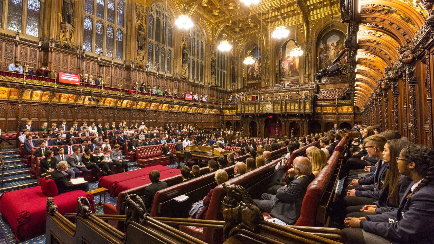 A debate occurring at the House of Commons with a mixture of House Lords and young pupils participating