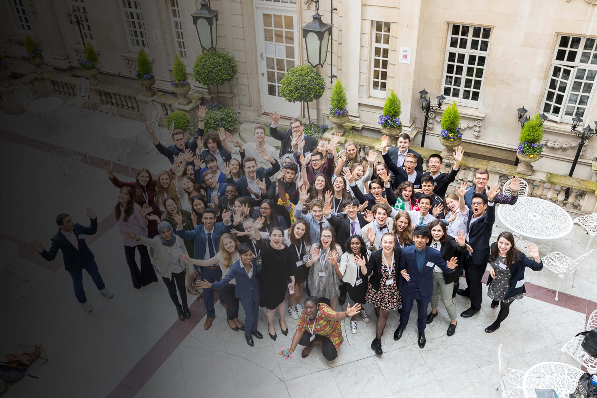 A group of IPSC scholars posing for a photo in the Dartmouth House courtyard