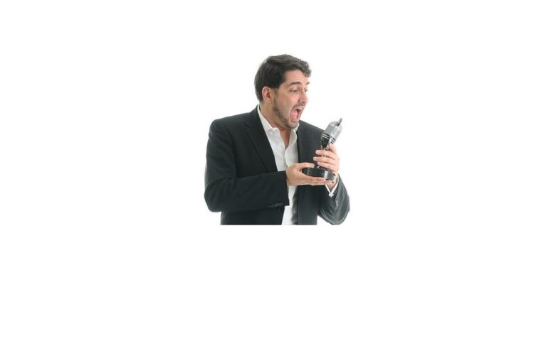 John Briggs posing with his award