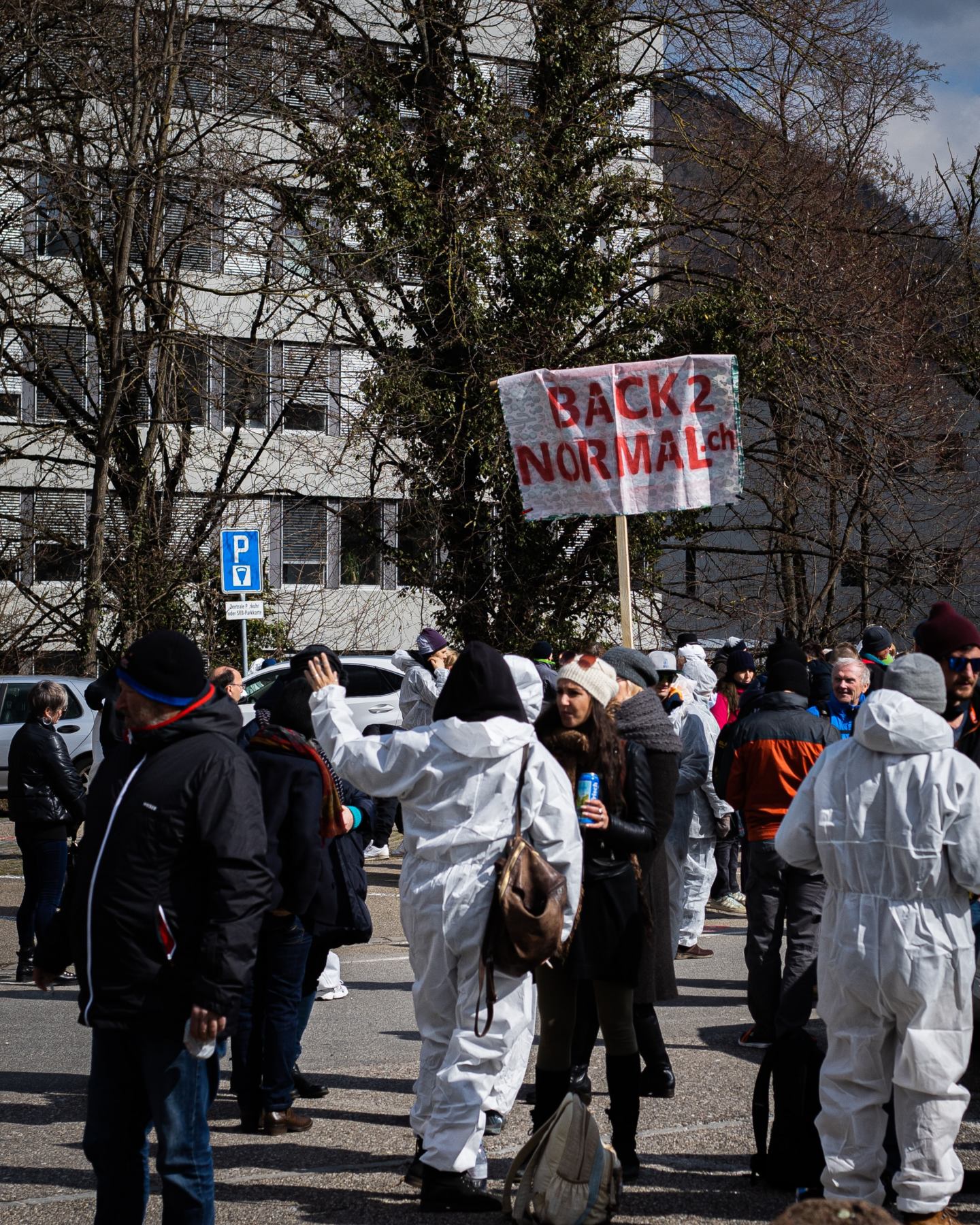 People protesting with the slogan "back 2 normal"