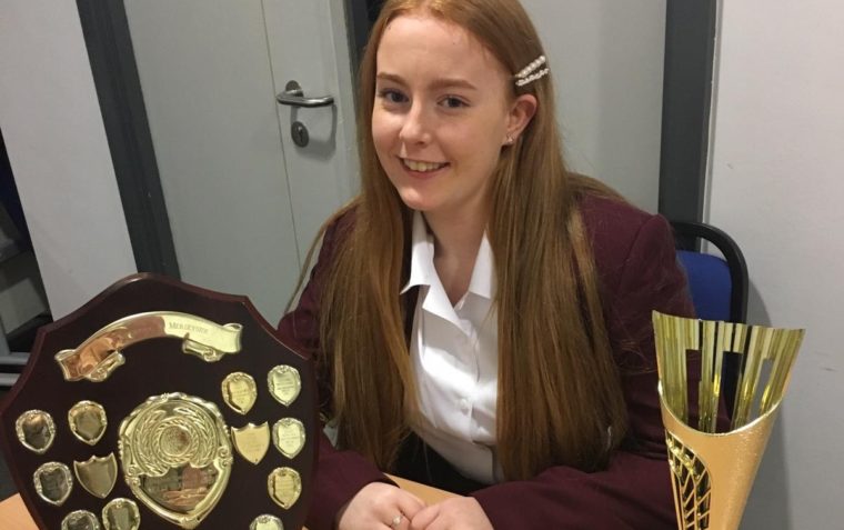 Young pupil posing with trophies