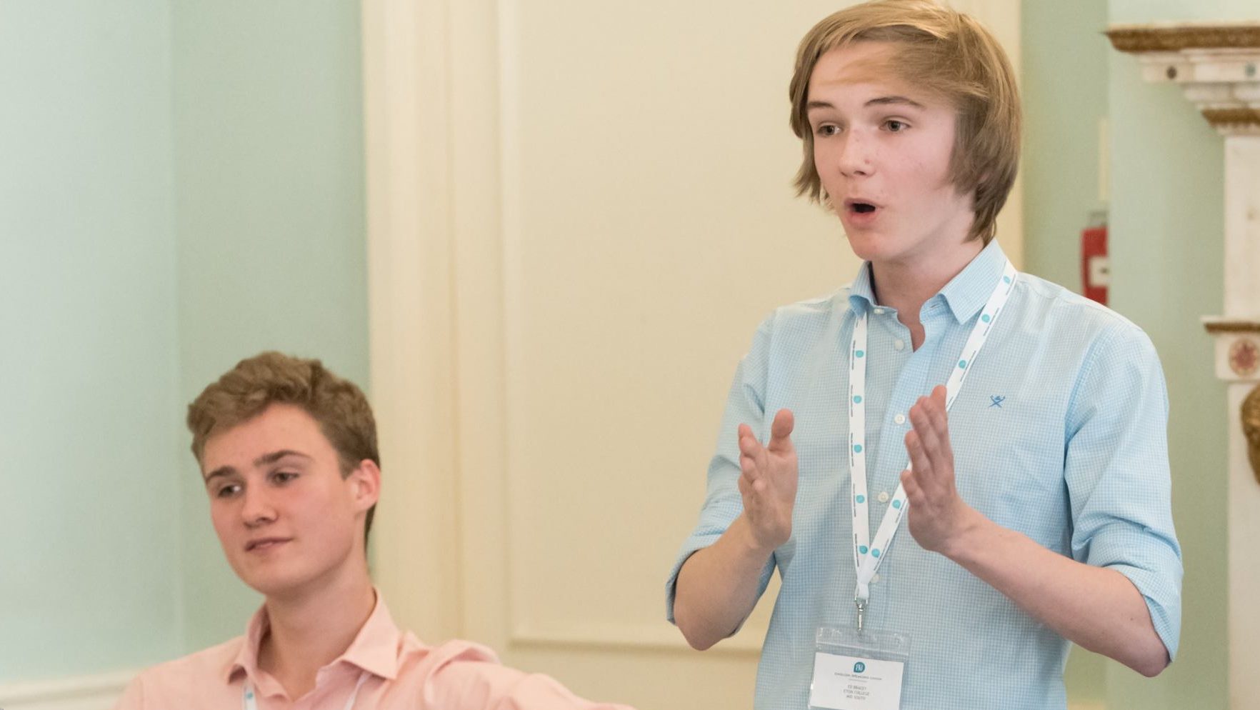 Eton College team speaking at the ESU Mace Competition. The speaker Ed Bracey is gesturing to make a point.
