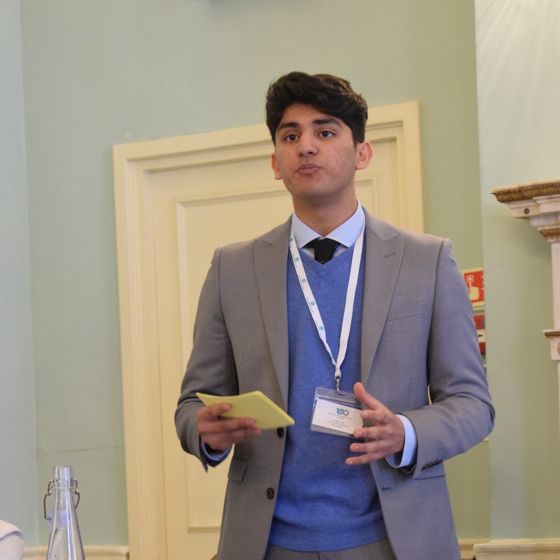 A pupil holding his cue cards while delivering his speech