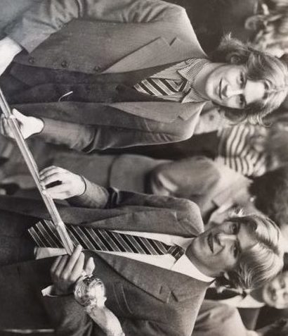 A black and white picture of Nick and Ed holding the winning Mace staff.