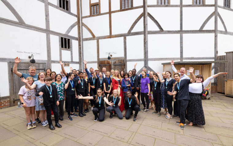 Performing Shakespeare participants standing outside of the Globe theatre