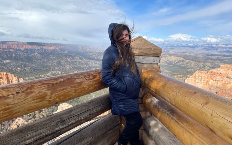 windswept girl on a hill
