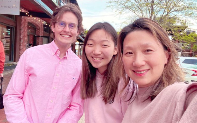 three people smiling at the camera