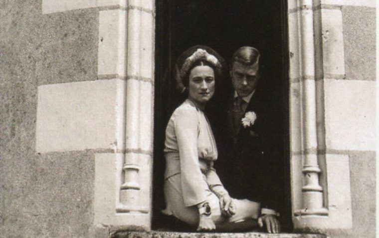 The Duke and Duchess of Windsor posing for a picture from their window